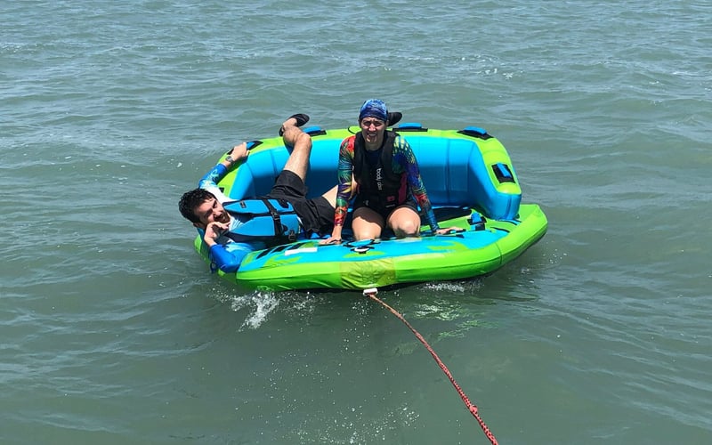 A man and a woman are riding a raft in the water.